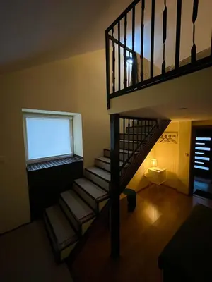 a spiral staircase in a room with a window at Vila Dvorište in Banja Luka