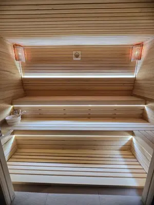 a sauna with wooden steps in a room at Romantic Lodge in Banja Luka