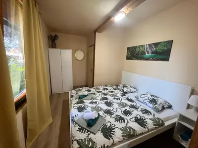 a small bedroom with a bed and a window at Haus Palazzo in Bosanska Krupa