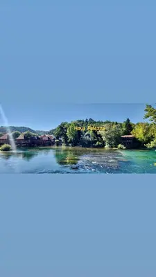 a view of a river with trees and houses at Haus Palazzo in Bosanska Krupa