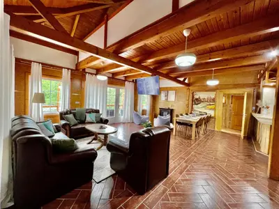 a living room with leather furniture and a dining room at Haus Palazzo in Bosanska Krupa