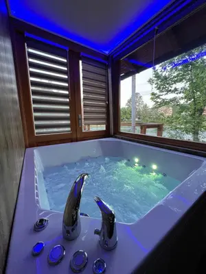a jacuzzi tub in a room with blue lighting at Haus Palazzo in Bosanska Krupa