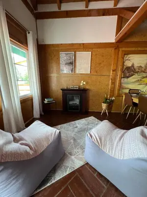 a bedroom with two beds and a fireplace at Haus Palazzo in Bosanska Krupa