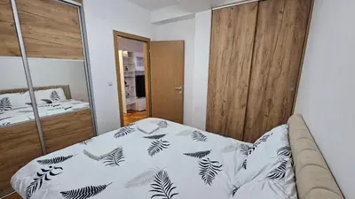a bedroom with a bed and a mirror at Apartman Dolores in Banja Luka