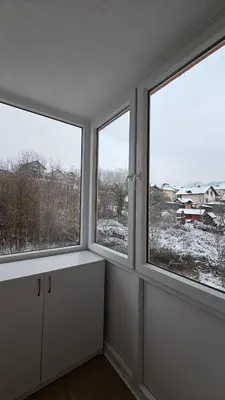 a room with three windows with snow at Apartman Dolores in Banja Luka