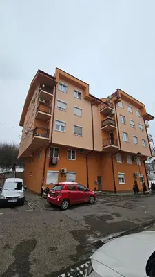a red car parked in front of a building at Apartman Dolores in Banja Luka