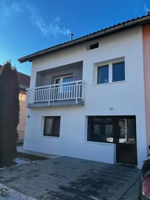 a white house with a balcony on it at Apartman Lara in Kupres