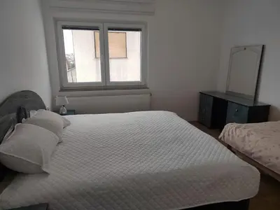 a bedroom with a large bed and a window at Apartman Lara in Kupres