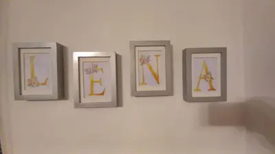 a group of four framed pictures on a wall at Apartman Lena Doboj in Doboj