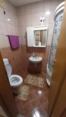 a bathroom with a toilet and a sink at Apartman Lena Doboj in Doboj