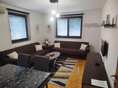 a living room with a couch and a table at Apartman Lena Doboj in Doboj
