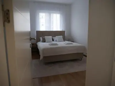 a bedroom with a bed and a window at Stan na dan Apartman ADA Banjaluka in Banja Luka