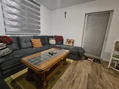 a living room with a couch and a coffee table at Planinska kuća Ruža in Kupres