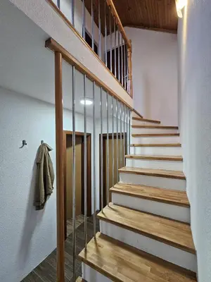 a staircase in a house with wooden railings at Planinska kuća Ruža in Kupres