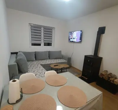 a living room with a couch and a table at Apartman Iva in Kupres