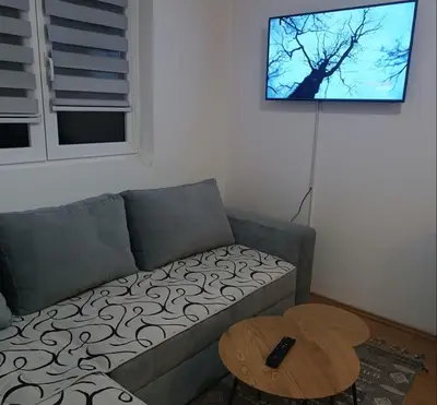 a living room with a couch and a table at Apartman Iva in Kupres