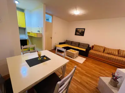 a living room with a table and a couch at Apartman Stefan in Banja Luka