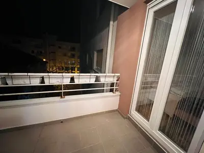 a balcony with a window and a cat on it at Apartman Stefan in Banja Luka