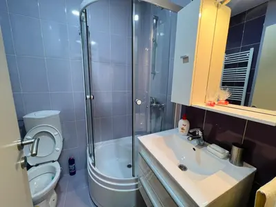 a bathroom with a shower and a toilet and a sink at Apartman Stefan in Banja Luka