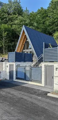 a house with two garage doors and a roof at UNA RESORT in Bosanska Krupa