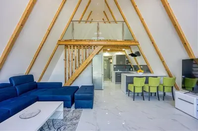 a living room with a blue couch and green chairs at UNA RESORT in Bosanska Krupa