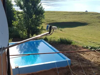 a swimming pool on the side of a house at Apartmani Šćit in Šćit