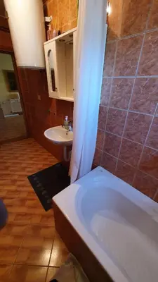 a bathroom with a white tub and a sink at Apartmani Šćit in Šćit