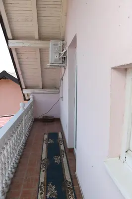 a balcony with a air conditioner on the side of a building at Holiday Home Peaceful Retreat in Visoko