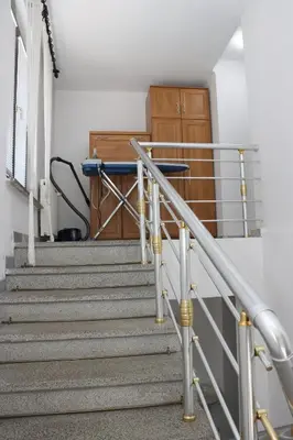 a set of stairs in a building with a wooden door at Holiday Home Peaceful Retreat in Visoko