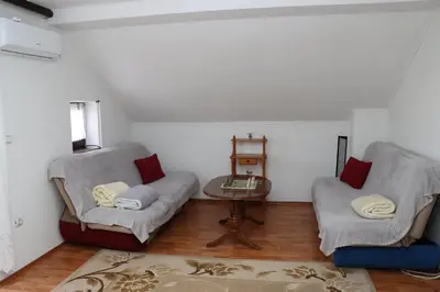 a living room with two chairs and a table at Holiday Home Peaceful Retreat in Visoko