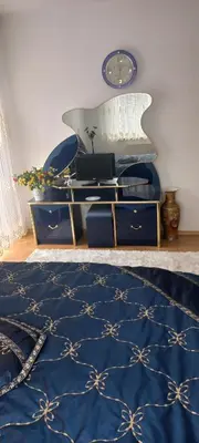 a room with a blue and white rug and a desk at Holiday Home Peaceful Retreat in Visoko