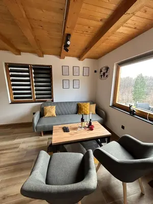 a living room with a couch and chairs and a table at Jerry's Cottage Banja Luka in Banja Luka