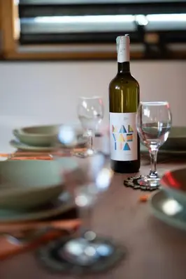 a bottle of wine sitting on a table with two glasses at Jerry's Cottage Banja Luka in Banja Luka