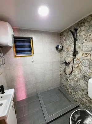 a bathroom with a shower and a sink at Jerry's Cottage Banja Luka in Banja Luka