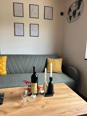 a table with two bottles of wine on it at Jerry's Cottage Banja Luka in Banja Luka