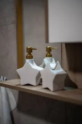 a bathroom with two sinks and two faucets at Jerry's Cottage Banja Luka in Banja Luka