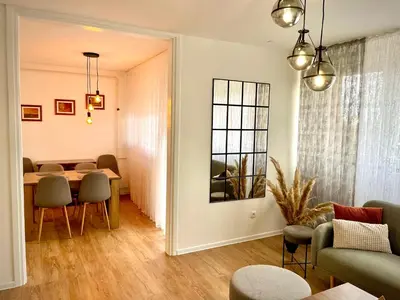 a living room with a table and chairs at Apartman BRONX Prijedor in Prijedor