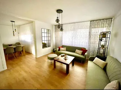 a living room with a couch and a table at Apartman BRONX Prijedor in Prijedor
