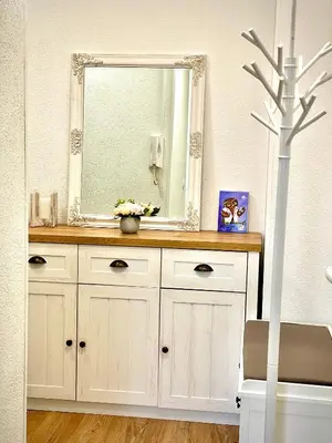 a mirror on top of a dresser in a bathroom at Apartman BRONX Prijedor in Prijedor