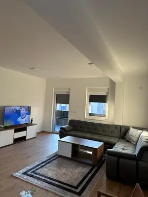 a living room with a couch and a flat screen tv at Restoran&Motel and apartmants Lovacka prica in Tešanj