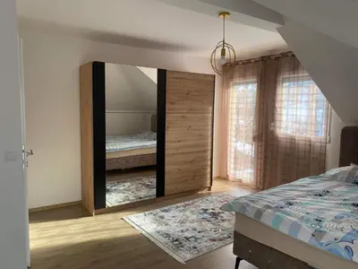 a bedroom with a large mirror and a bed at Vila BD in Milešići