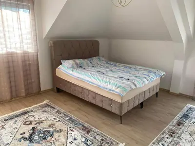 a bed in a room with two rugs at Vila BD in Milešići