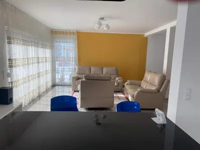 a living room with couches and blue chairs in it at Vila BD in Milešići