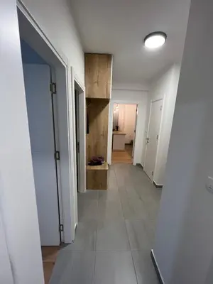 a hallway of an apartment with white walls and tile floors at Apartment CHILL in Banja Luka