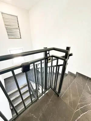 a stair railing in a room with a table at Apartment CHILL in Banja Luka