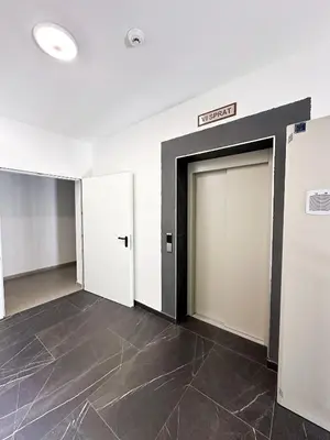 a room with two doors and a sign on the wall at Apartment CHILL in Banja Luka