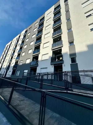 a tall building with a fence in front of it at Apartment CHILL in Banja Luka
