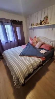 a large bed in a bedroom with two windows at Bosnien Old House in Travnik