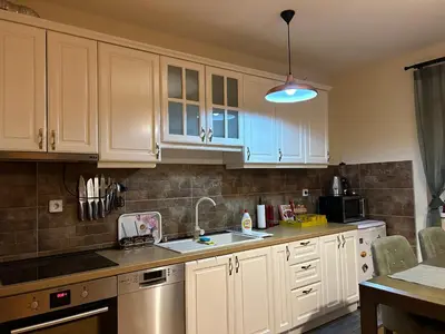 a kitchen with white cabinets and a sink at Apartman Obala in Bosanska Gradiška