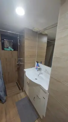 a bathroom with a sink and a shower at Vikendica Rajvosa Vlašić in Šišava
